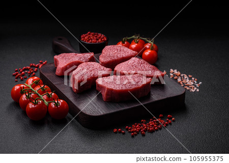 Juicy fresh raw beef meat with salt, spices and herbs Juicy fresh raw beef meat with salt, spices and herbs 105955375