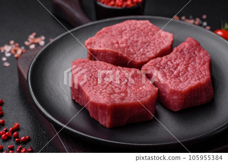 Juicy fresh raw beef meat with salt, spices and herbs Juicy fresh raw beef meat with salt, spices and herbs 105955384