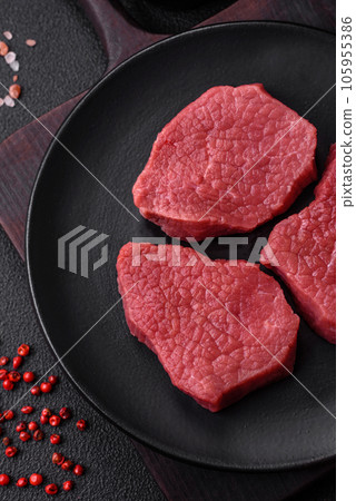 Juicy fresh raw beef meat with salt, spices and herbs Juicy fresh raw beef meat with salt, spices and herbs 105955386
