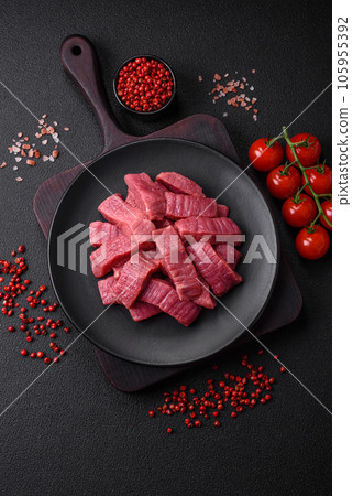 Juicy fresh raw beef meat with salt, spices and herbs Juicy fresh raw beef meat with salt, spices and herbs 105955392