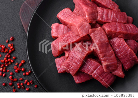 Juicy fresh raw beef meat with salt, spices and herbs Juicy fresh raw beef meat with salt, spices and herbs 105955395