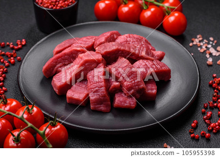 Juicy fresh raw beef meat with salt, spices and herbs Juicy fresh raw beef meat with salt, spices and herbs 105955398