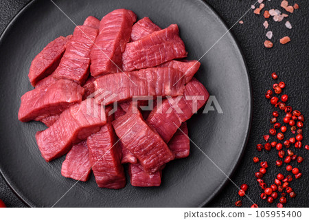 Juicy fresh raw beef meat with salt, spices and herbs 105955400