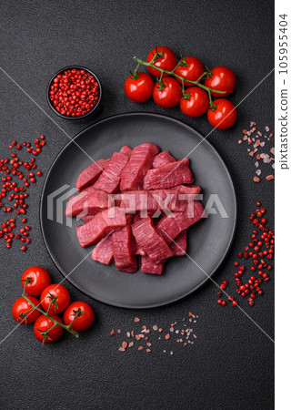 Juicy fresh raw beef meat with salt, spices and herbs Juicy fresh raw beef meat with salt, spices and herbs 105955404