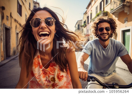 Couple on bike together riding in a city Couple on bike together riding in a city 105956264
