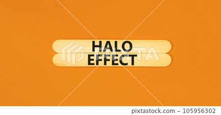 Halo effect and psychological symbol. Concept words Halo effect on beautiful wooden stick. Beautiful orange table orange background. Business psychological and Halo effect concept. Copy space. 105956302