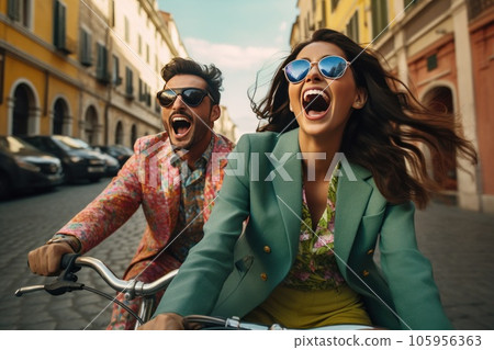Couple on bike together riding in a city 105956363