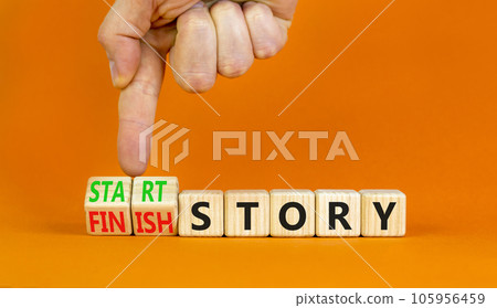 Start or finish story symbol. Concept words Start story and Finish story on wooden cubes. Beautiful orange table orange background. Businessman hand. Business start or finish story concept. Copy space 105956459