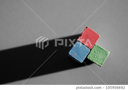 Multi-colored crayons for drawing close-up, on a gray background. Top view Poster for advertising chalk, preparation for school 105956692