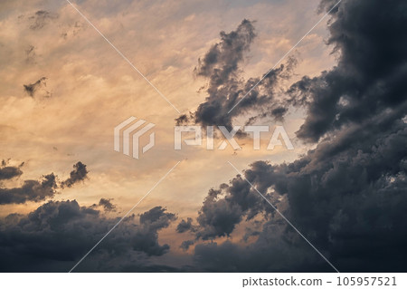 Dramatic colorful twilight sky before a thunderstorm with wind clouds on a black sea beach Selective focus on the clouds Dramatic colorful twilight sky before a thunderstorm with wind clouds on a black sea beach Selective focus on the clouds 105957521