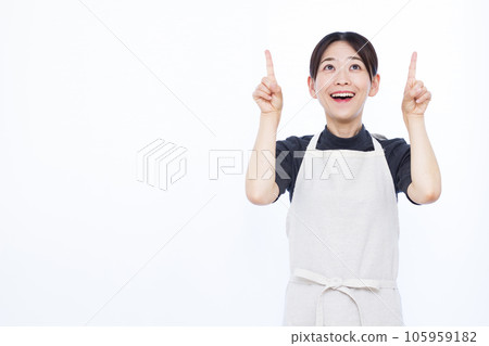 Housewife in her thirties pointing to the ceiling in front of a white background Housewife in her thirties pointing to the ceiling in front of a white background 105959182