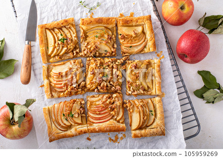 Apple tart with puff pastry tpped with walnuts and brown sugar Apple tart with puff pastry tpped with walnuts and brown sugar 105959269