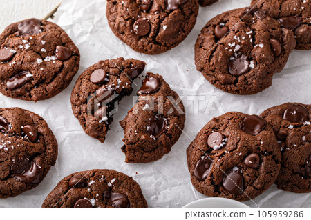 Double chocolate cookies with dark chocolate chips and salt flakes Double chocolate cookies with dark chocolate chips and salt flakes 105959286