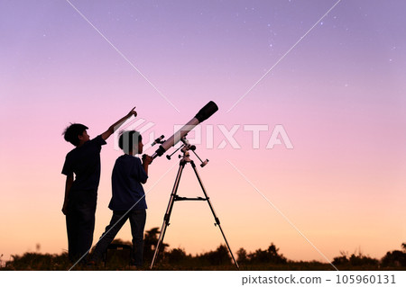 Silhouettes of children doing astronomical observation 105960131