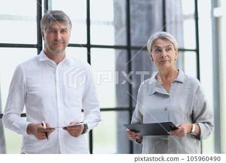Business people meet in the office and discuss joint business projects Business people meet in the office and discuss joint business projects 105960490
