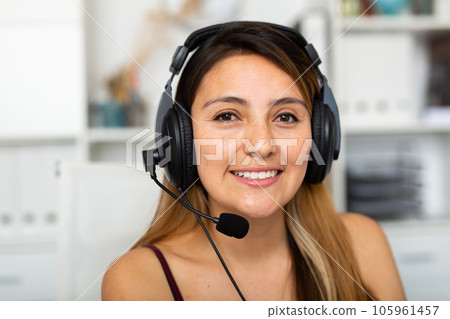 Young woman call centre operator with headphones working Young woman call centre operator with headphones working 105961457