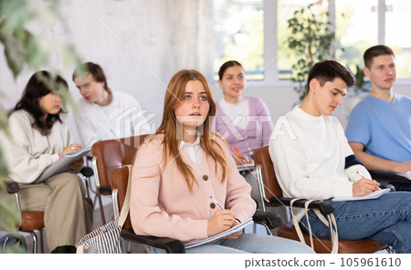Group of high school students listening to lecture in auditorium 105961610