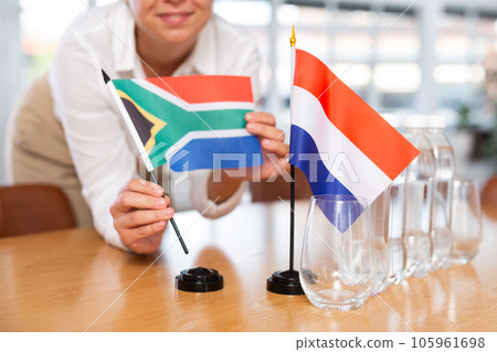 Blurry girl set midget flags of South Africa and Netherlands before international negotiations Blurry girl set midget flags of South Africa and Netherlands before international negotiations 105961698