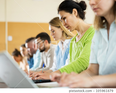 Group students listening and writing during business course Group students listening and writing during business course 105961879