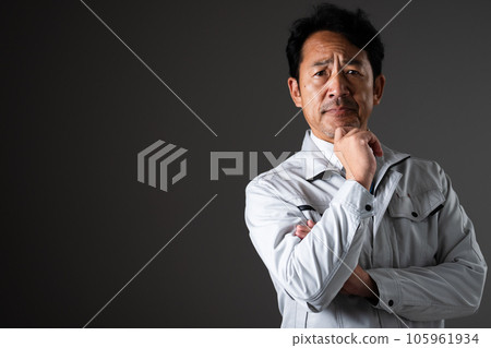 Worried middle-aged man Work clothes image Worried middle-aged man Work clothes image 105961934