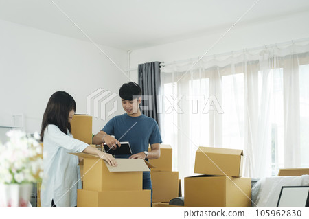 Young married couple moving into new home. Young married couple moving into new home. 105962830