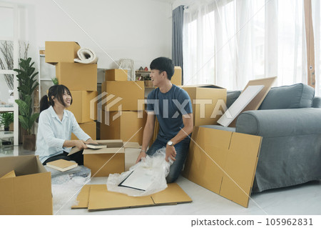 Young married couple moving into new home. 105962831