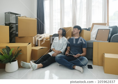 Young married couple moving into new home. 105962837