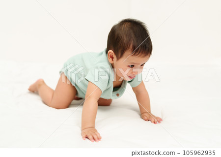 happy infant crawling on floor inside baby playpen happy infant crawling on floor inside baby playpen 105962935