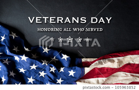 Happy Veterans day concept with flag of the United States and the text on black wooden background. Happy Veterans day concept with flag of the United States and the text on black wooden background. 105963852