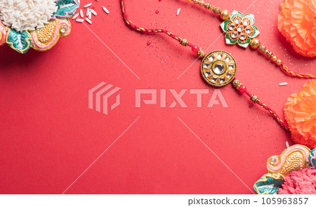 Raksha Bandhan, Indian festival with beautiful Rakhi and Rice Grains.  A traditional Indian wrist band which is a symbol of love between Sisters and Brothers. 105963857