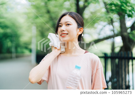 Woman wiping sweat outdoors 105965273