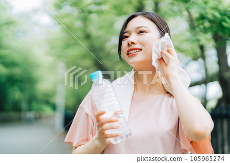 Woman wiping sweat outdoors 105965274