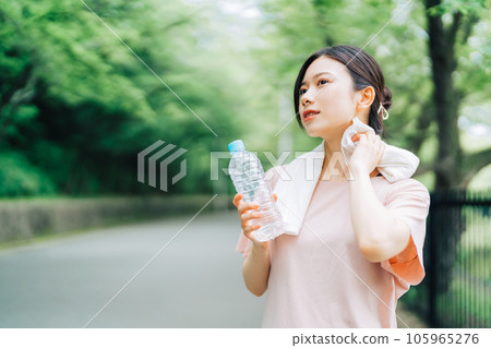 Woman wiping sweat outdoors 105965276