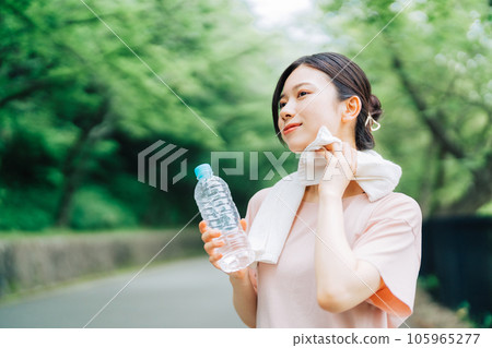 Woman wiping sweat outdoors 105965277