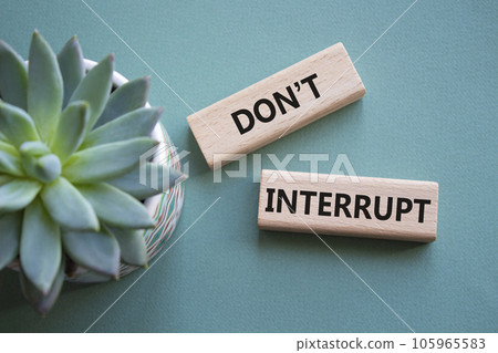 Dont interrupt symbol. Concept word Dont interrupt on wooden blocks. Beautiful grey green background with succulent plant. Business and Dont interrupt concept. Copy space Dont interrupt symbol. Concept word Dont interrupt on wooden blocks. Beautiful grey green background with succulent plant. Business and Dont interrupt concept. Copy space 105965583