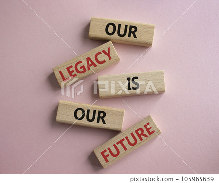 Our Legacy is our Future symbol. Concept words Our Legacy is our Future on wooden blocks. Beautiful pink background. Business and Our Legacy is our Future concept. Copy space 105965639