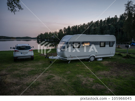 Night campsite camping caravan by lake Ragnerudssjoen in Dalsland Sweden beautiful nature forest pinetree 105966045