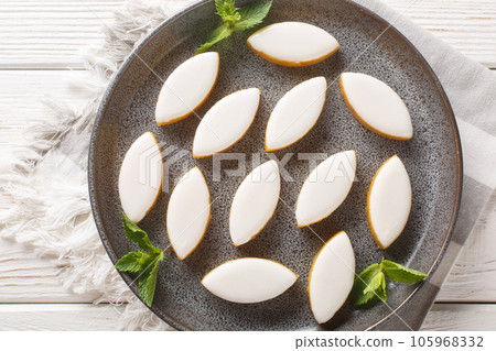 Calissons French glazed almonds bonbons with white icing closeup. Horizontal top view 105968332