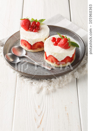 French mini Cake Fraisier With Fresh Strawberries and redcurrant closeup on the plate. Vertical French mini Cake Fraisier With Fresh Strawberries and redcurrant closeup on the plate. Vertical 105968363