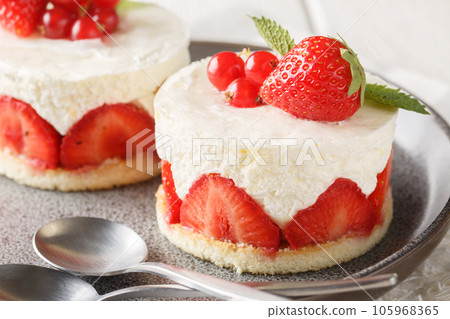 French strawberry Fraisier cake consists of buttery sponge layers filled with silky cream mousseline closeup on the plate. Horizontal French strawberry Fraisier cake consists of buttery sponge layers filled with silky cream mousseline closeup on the plate. Horizontal 105968365