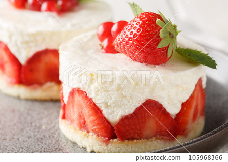 Fraisier cake is a French strawberry cake made from layers of genoise, mousseline cream and strawberries closeup on the plate. Horizontal Fraisier cake is a French strawberry cake made from layers of genoise, mousseline cream and strawberries closeup on the plate. Horizontal 105968366