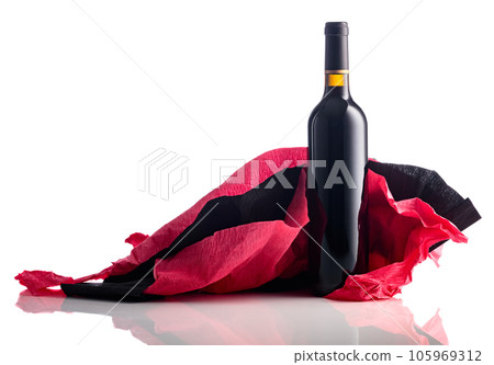 Bottle of red wine with crumpled crepe paper isolated on a white background. Bottle of red wine with crumpled crepe paper isolated on a white background. 105969312