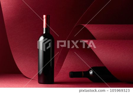 Bottles of red wine on a red background. 105969323