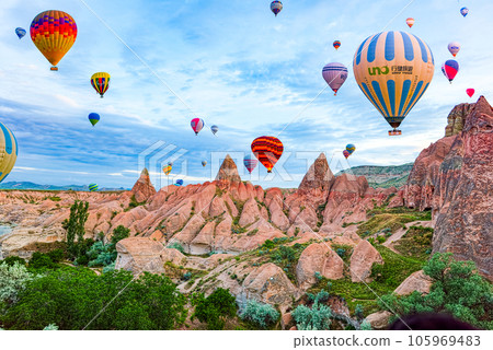 Cappadocia, Turkiye - July 07, 2023-Air balloons in Cappadocia-unreal views in valley. 105969483
