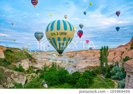 Cappadocia, Turkiye - July 07, 2023-Air balloons in Cappadocia-unreal views in valley. 105969489