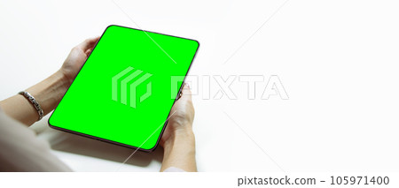 Mockup image, woman holding black digital tablet with blank green screen on white background. 105971400