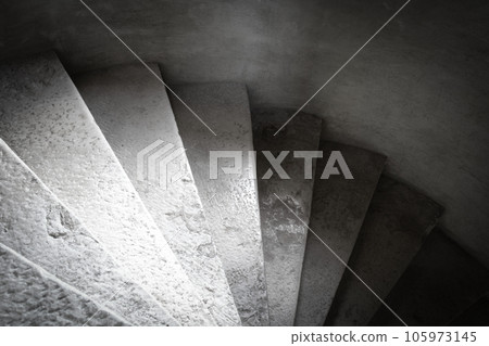 Close up shot of a stone spiral staircase in a French building 105973145