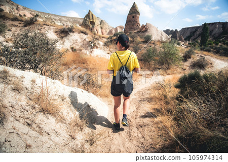 Rear view of woman trekking in Cappadocia mountains, Turkey Rear view of woman trekking in Cappadocia mountains, Turkey 105974314