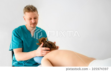 Masseur doing massage a girl's neck in a massage parlor. Healthcare and relaxation procedures. 105974397