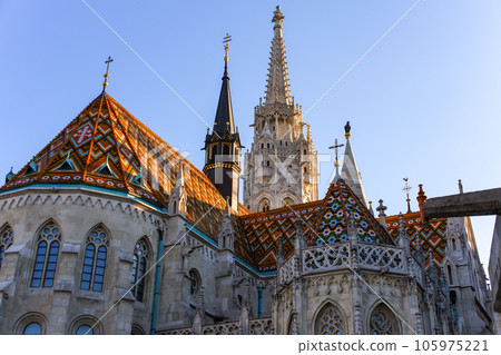 Colorful roof tiles and towers of Matthias Cathedral in the Buda Castle district Colorful roof tiles and towers of Matthias Cathedral in the Buda Castle district 105975221